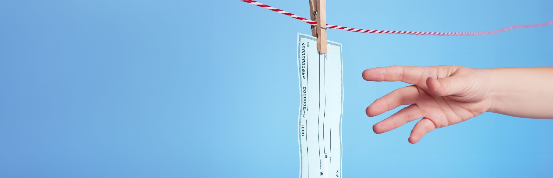 Image of a blank check on a clothesline.